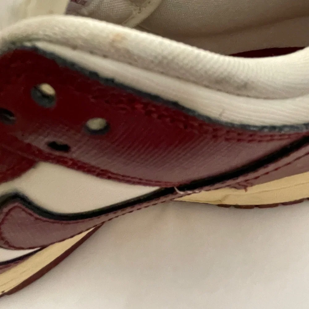 Nike Women’s White and Burgundy Sneakers with Gold Accents